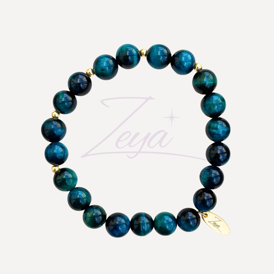 Plongez dans la profondeur des océans avec le Bracelet Atlantis, un bijou puissant et captivant façonné à partir d’Œil de Tigre Océan. Cette pierre rare, aux nuances riches et ondoyantes, évoque le mouvement fluide des vagues et la force tranquille des eaux profondes.